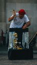 Photo of a Man in a White Shirt Controlling a Skeleton Puppet