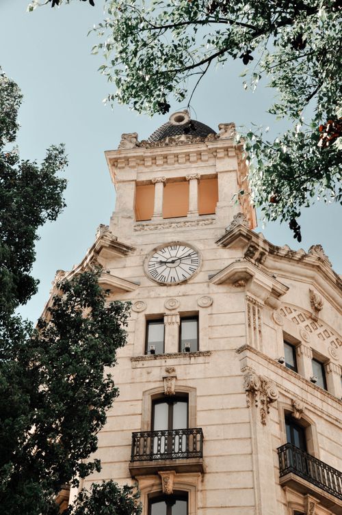 Free A classic architectural facade of a historic clock tower in Barcelona, Spain. Stock Photo