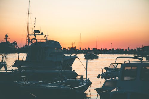 Free Several Boats on Calm Water during Golden Hour Stock Photo