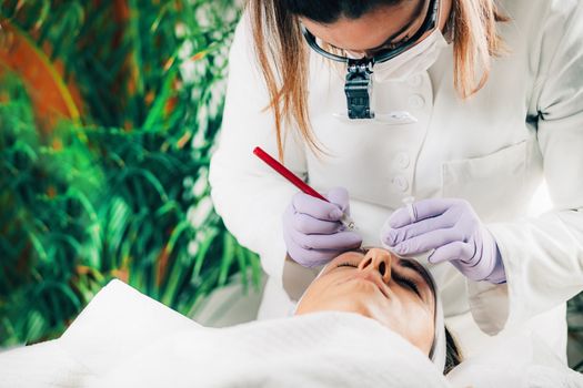 A beautician performs a cosmetic procedure on a client in a serene spa environment.