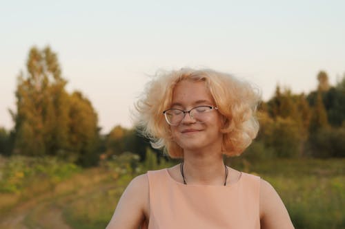 A Woman in Beige Tank Top Wearing Eyeglasses