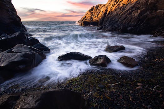 Waves crashing against rocky shores at sunset in Mölle, Sweden. Stunning natural scenery.