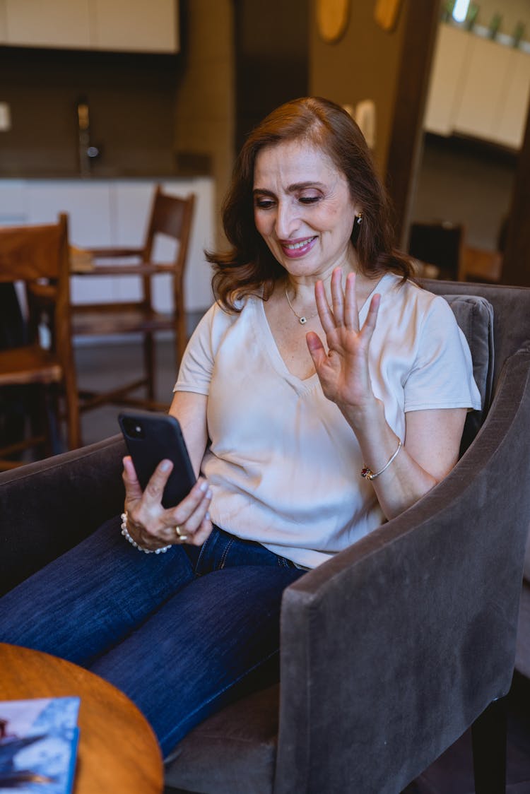 Woman Waving Her Hand While Video Calling