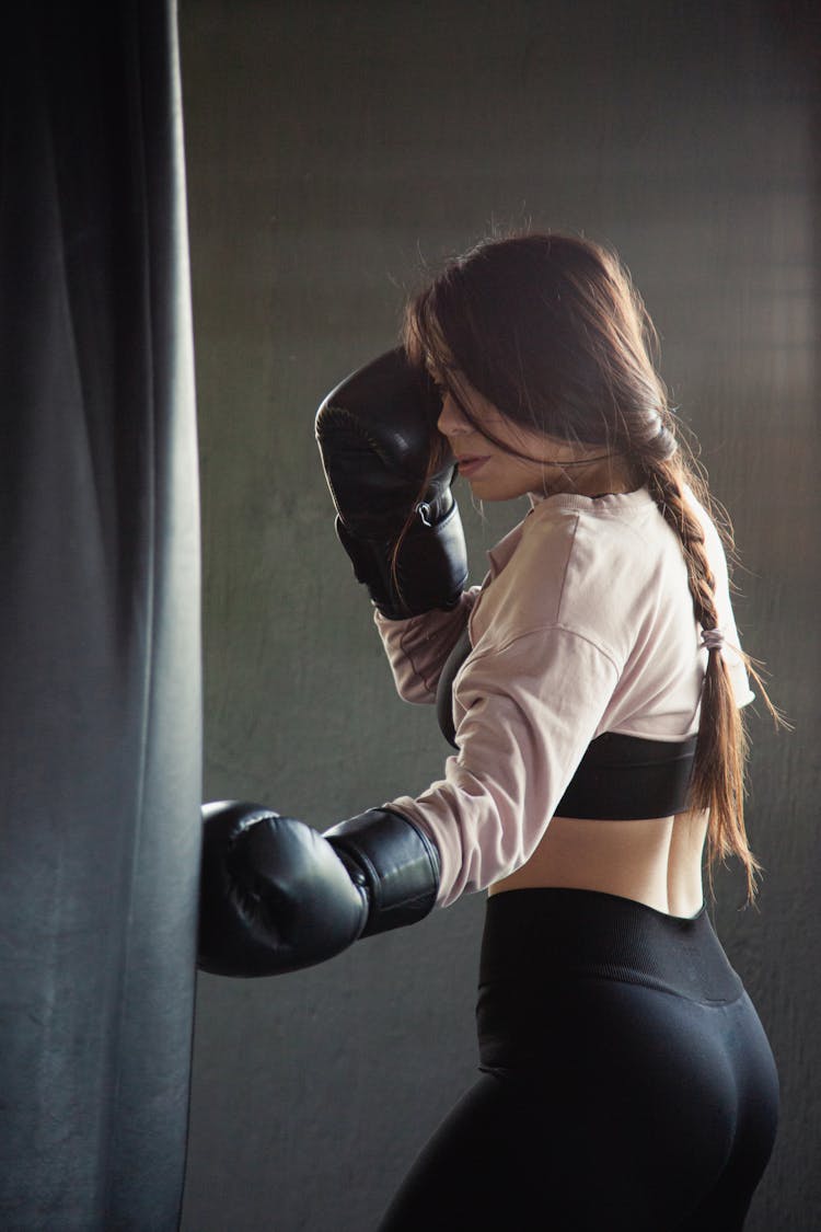 A Woman Punching A Heavy Bag 