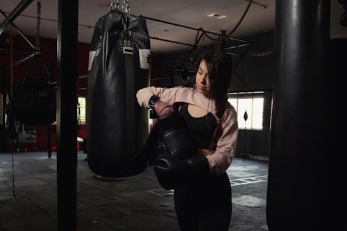 Woman Wearing Black Boxing Gloves