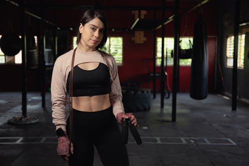 Toned Young Woman in Sportswear Posing in Gym