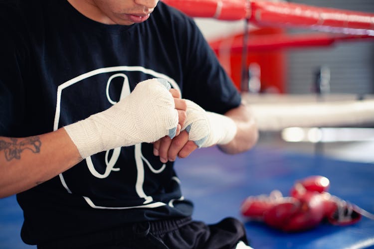 Man In Black Shirt Wearing Boxing Hand Wraps