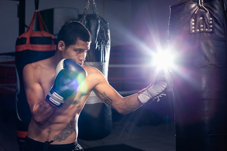 A Man Punching A Heavy Bag