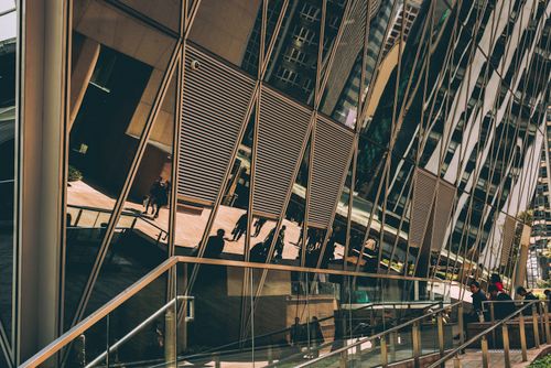 Free Futuristic Kowloon building with reflective glass panels, modern urban scene. Stock Photo