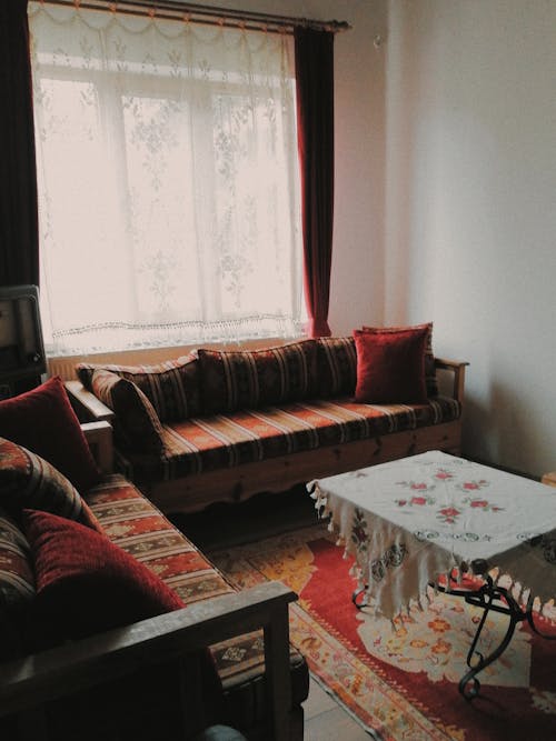 Free A Living Room with Sofa and Center Table Near the Window with Curtain Stock Photo