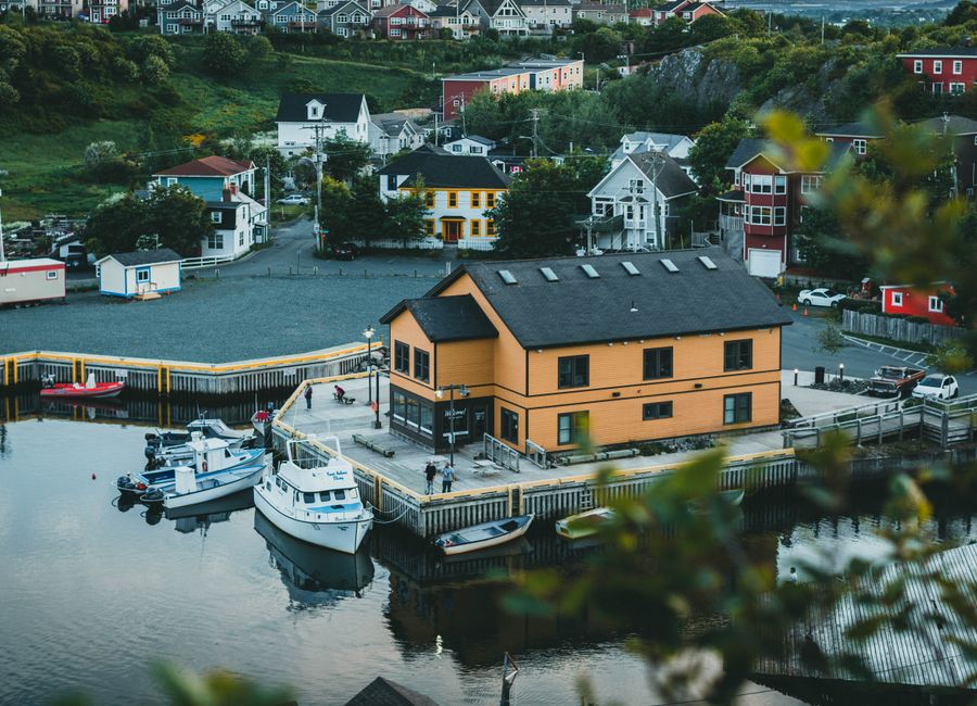 Charming aerial view of Quidi Vidi village and harbor with boats and colorful houses in St. John's, Newfoundland.