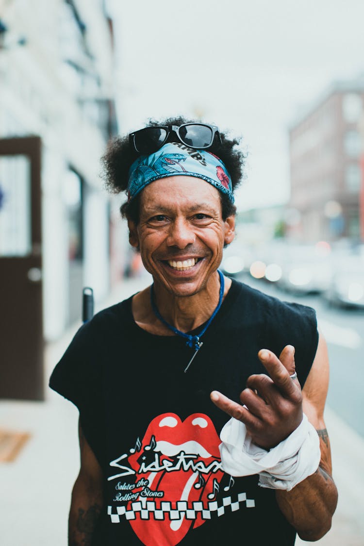 Portrait Of Smiling Cool Old Man Showing Hand Gesture