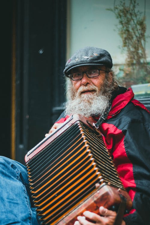 Elderly Man playing Musical Instrument 