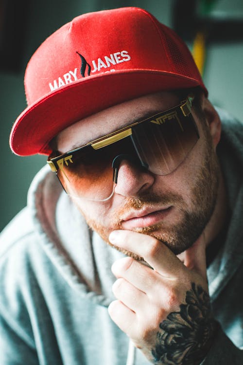 Portrait of a Young Man Wearing a Baseball Cap and Sunglasses