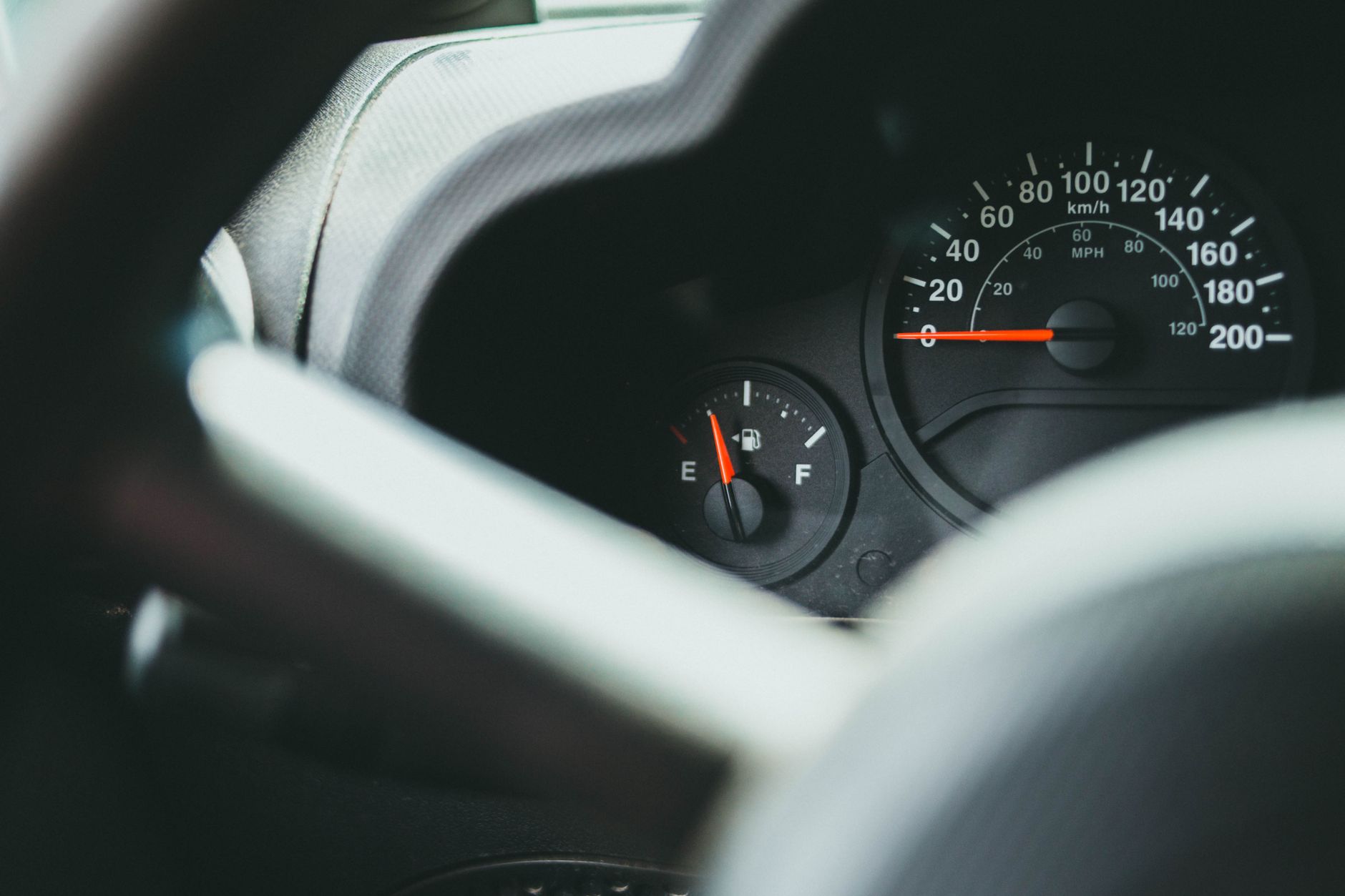 Tampilan mendetail dari dashboard mobil yang menunjukkan indikator speedometer dan bahan bakar.