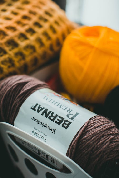 Brown Yarn and Orange Yarn Ball in Close Up View