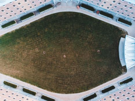 Drone shot of a symmetrical green courtyard surrounded by a building.