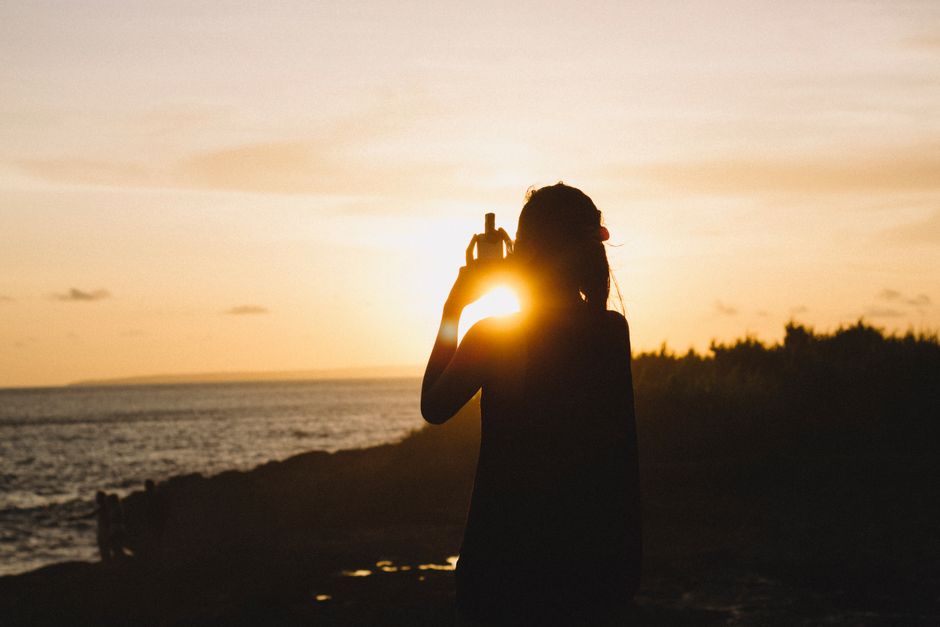 Capture of a serene silhouette against the glowing sunset at Nusapenida Beach, Bali.