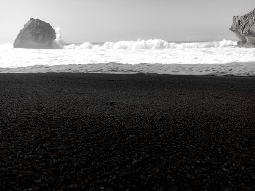 Grayscale Photo of Waves Crashing the Shore