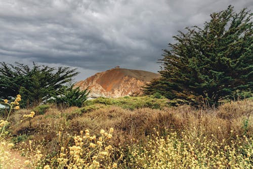 Scenic View of Rocky Mountain under Cloudy Sky 