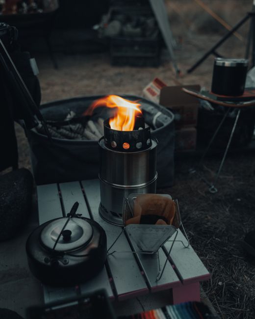 Solo Stove Campfire portable smokeless fire pit on a campsite table with glowing coals at dusk