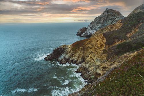 Free Breathtaking view of the rugged cliffs and ocean at Half Moon Bay, California during a dramatic sunset. Stock Photo