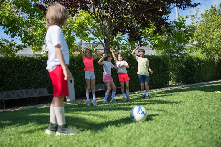 Children Playing Football Together