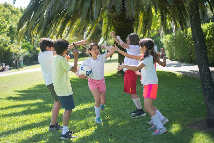 Children Playing Football Together