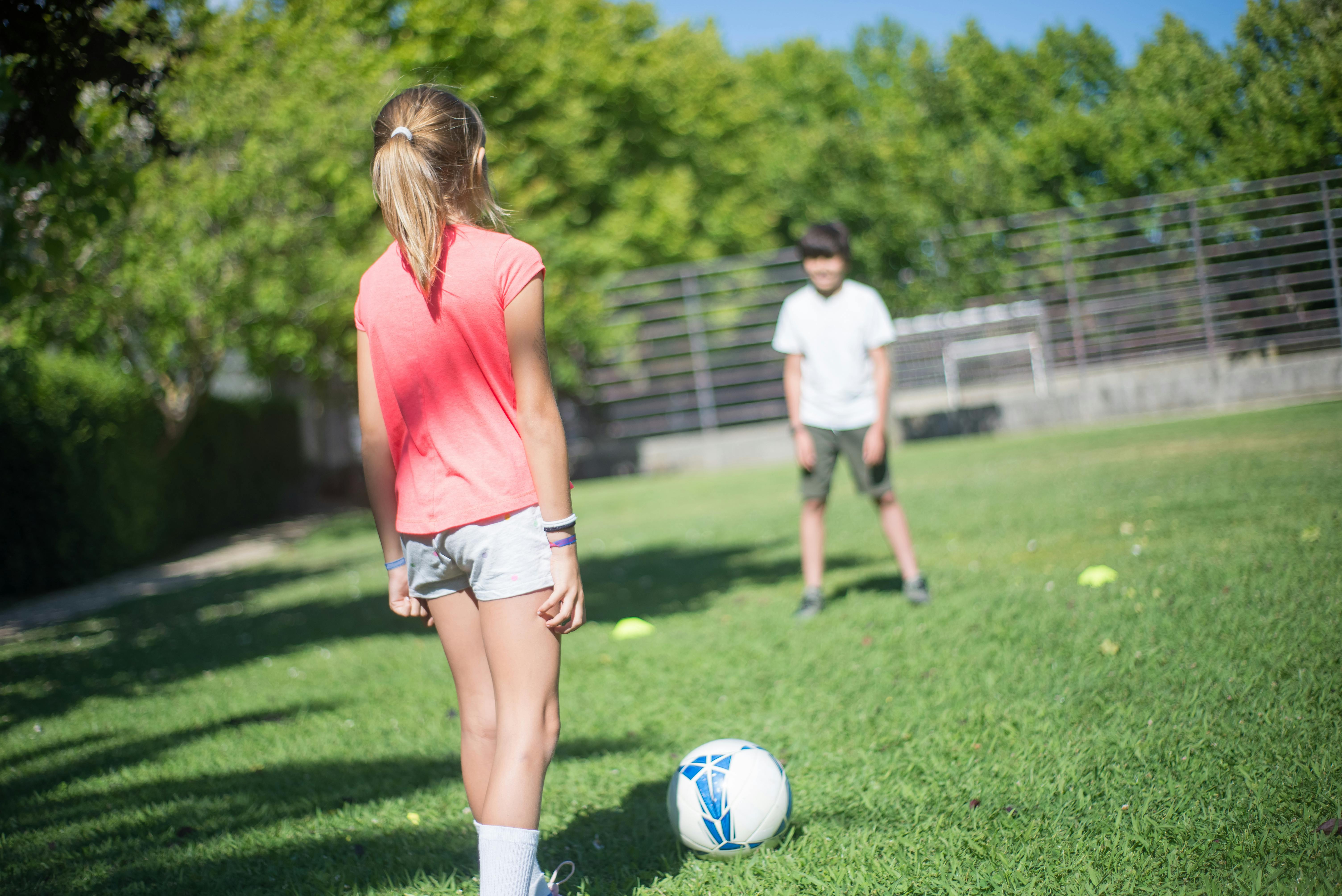 children playing football together