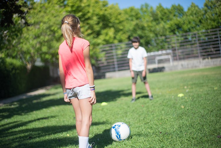 Children Playing Football Together 