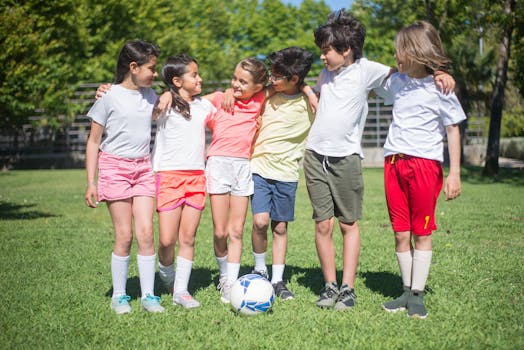 Children playing soccer on a sunny day in a park, bonding in friendship.