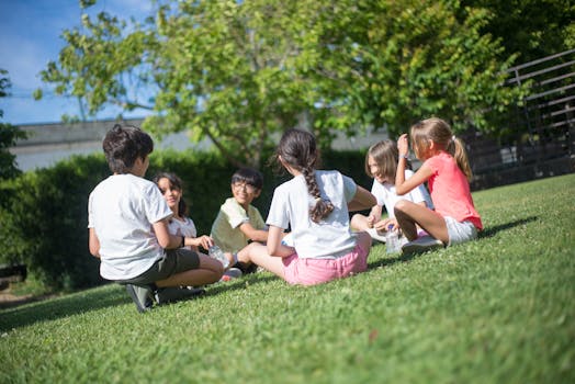 A group of children playing games and enjoying companionship in a sunny park.