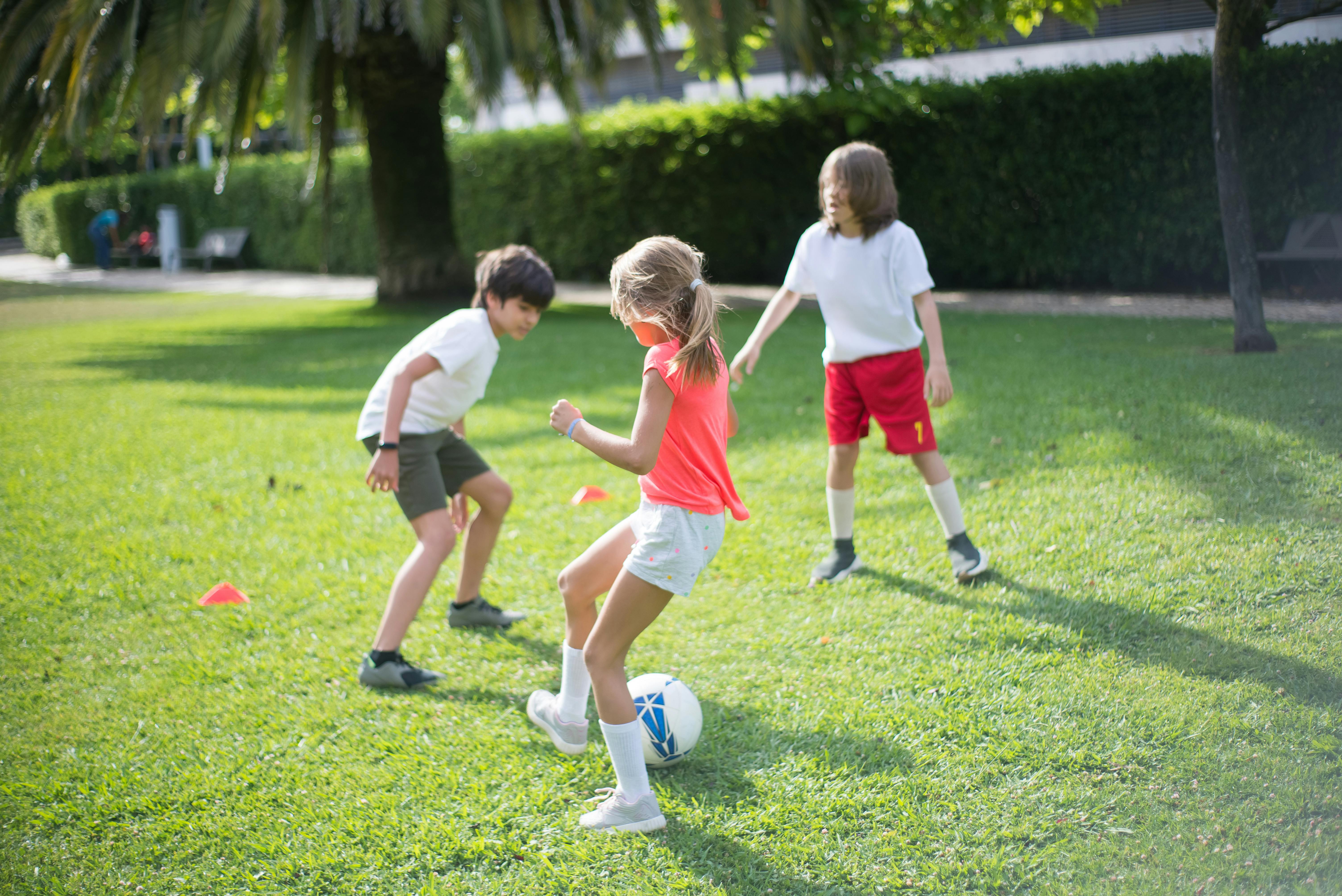 children playing football together