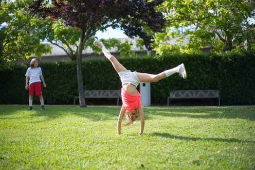 Girl tumbling on Green Grass