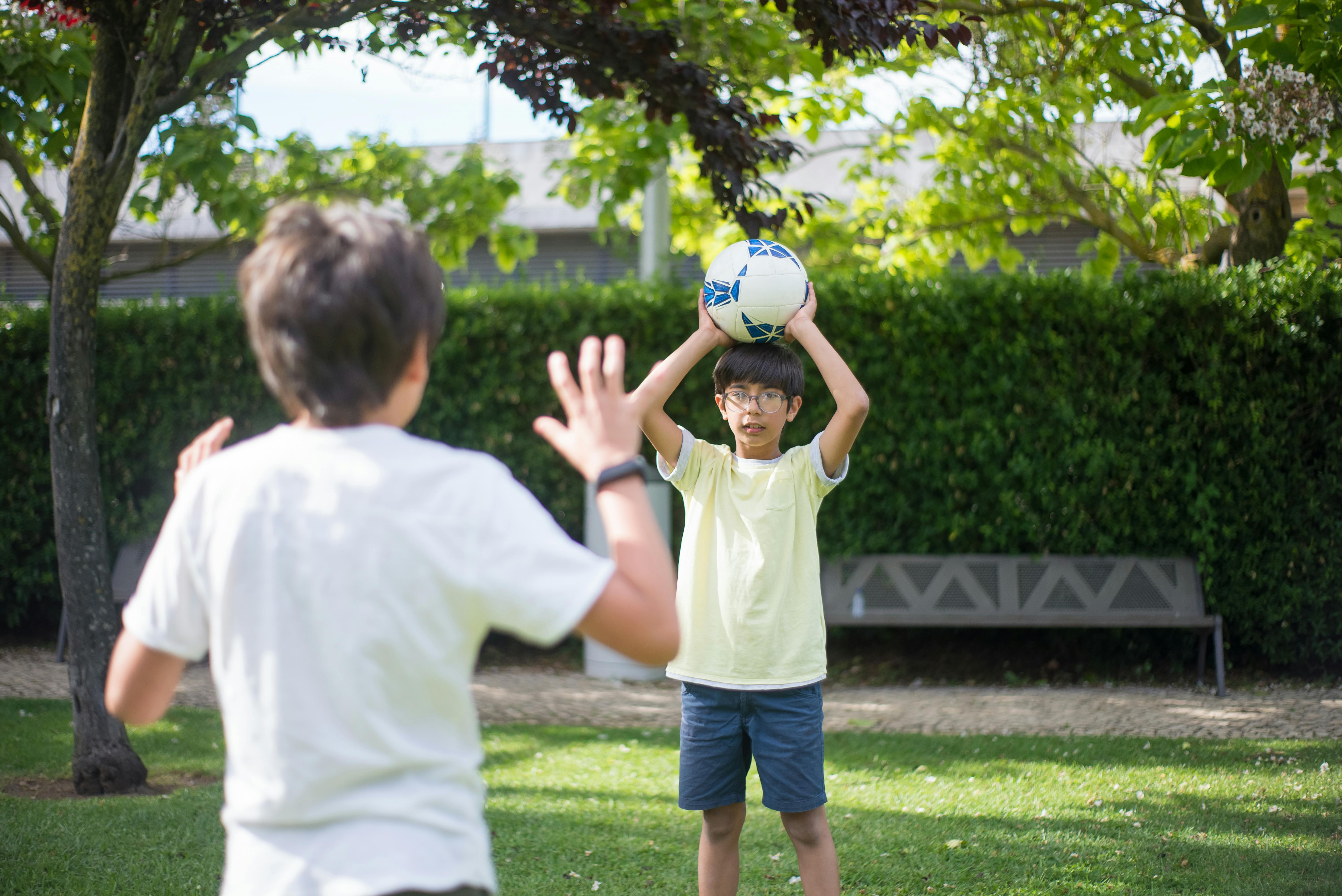 a boys playing soccer ball