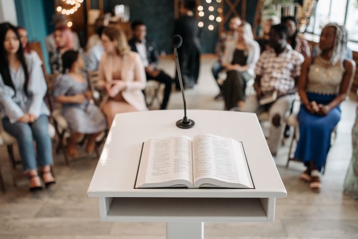 An open Bible and microphone on the pulpit
