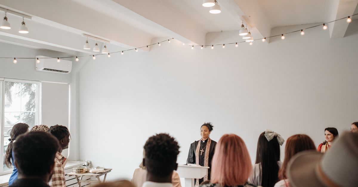Pastor Sola Dike speaking at Queens of Faith event with women smiling