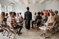 Group of People Sitting on Folding Chairs
