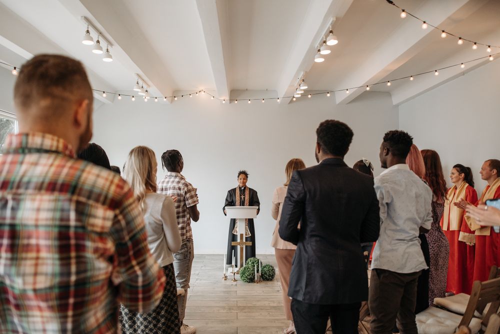 Diverse congregation praying together in church