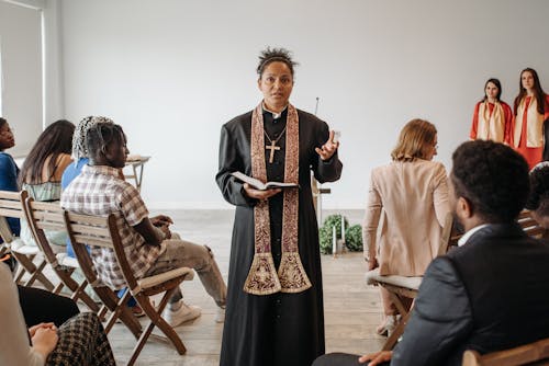 A Pastor Talking while Holding a Bible