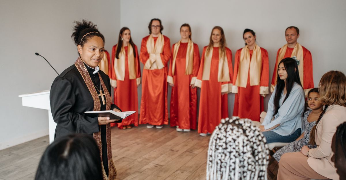 Pastor leading worship with congregation singing, natural lighting, authentic expression