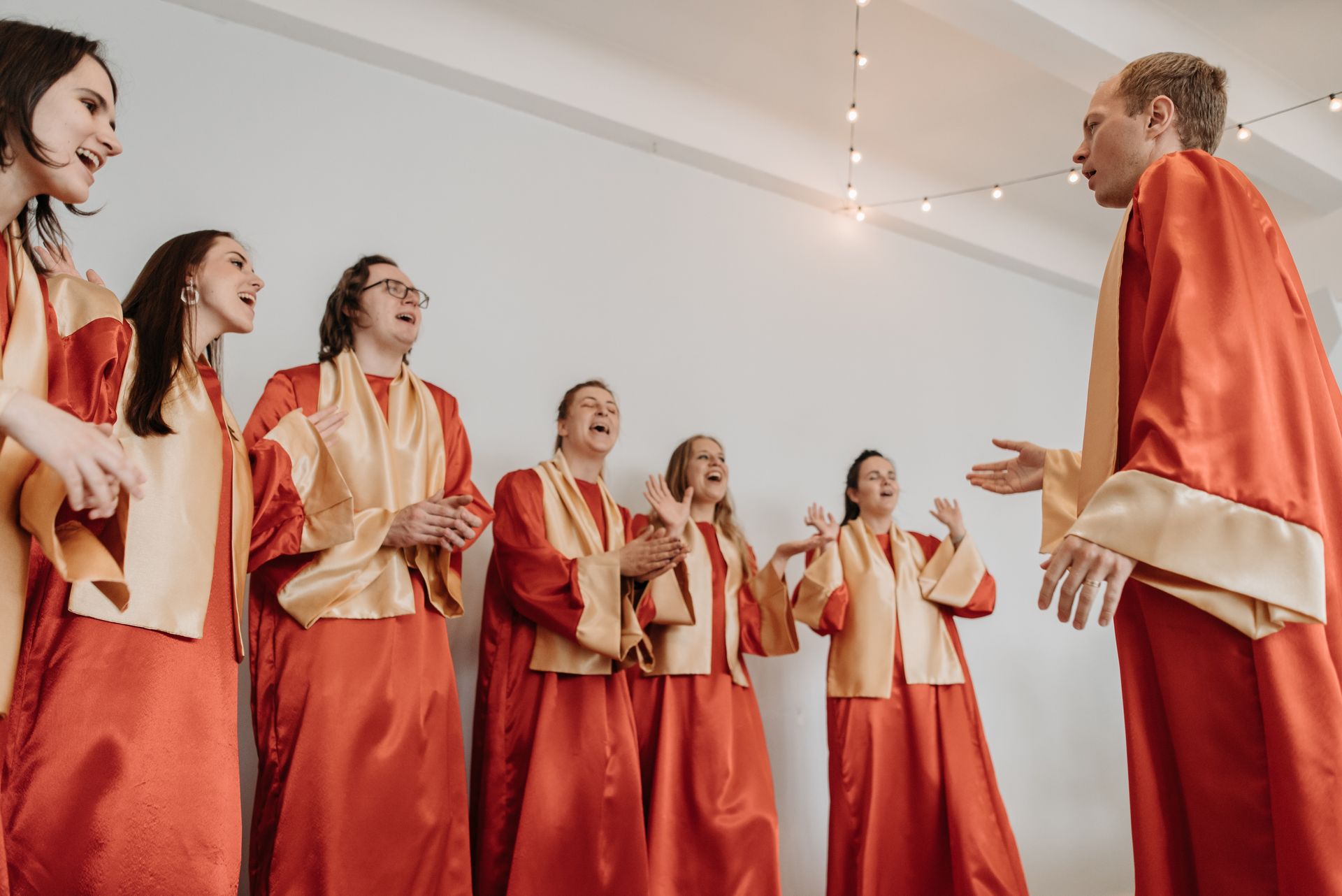 A choir in red robes singing in church