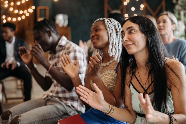 Smiling People Clapping Hands At A Celebration