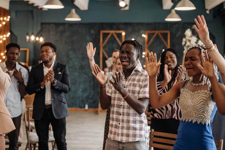 Group Of People Standing And Praising