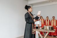 Man in Black Coat Standing Beside Woman in Red Dress