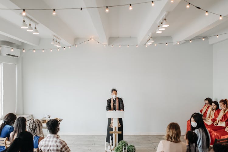 Woman Pastor Standing In Front Of People