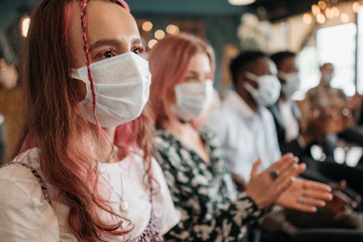 Young People in Face Masks Clapping Hands at a Celebration