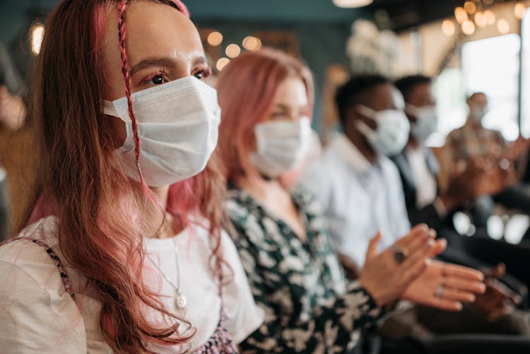 Young People In Face Masks Clapping Hands At A Celebration