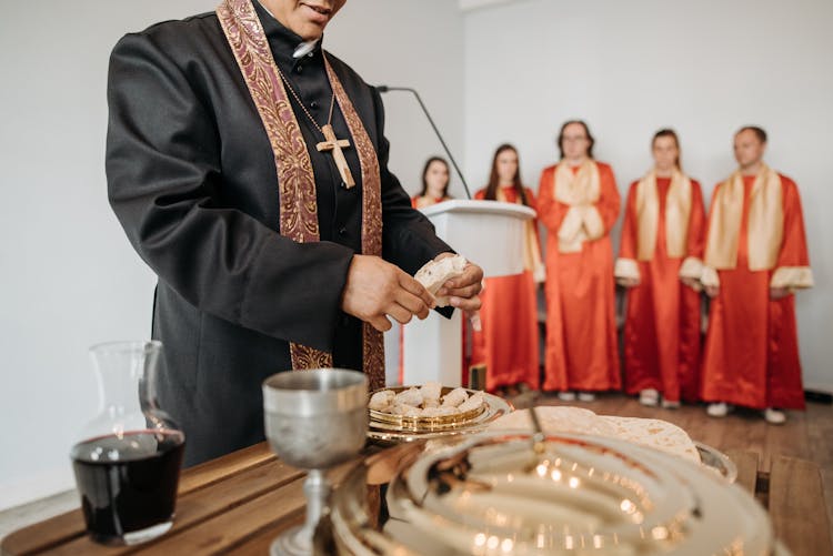 A Pastor Breaking Bread For Communion