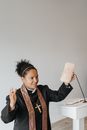 A Woman Pastor Holding a Bread